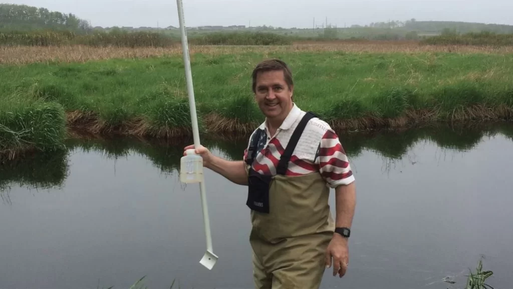 Friends of Pheasant Branch Conservancy Board Member Rick Eilertson doing monitoring work on Pheasant Branch Creek