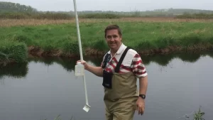 Friends of Pheasant Branch Conservancy Board Member Rick Eilertson doing monitoring work on Pheasant Branch Creek