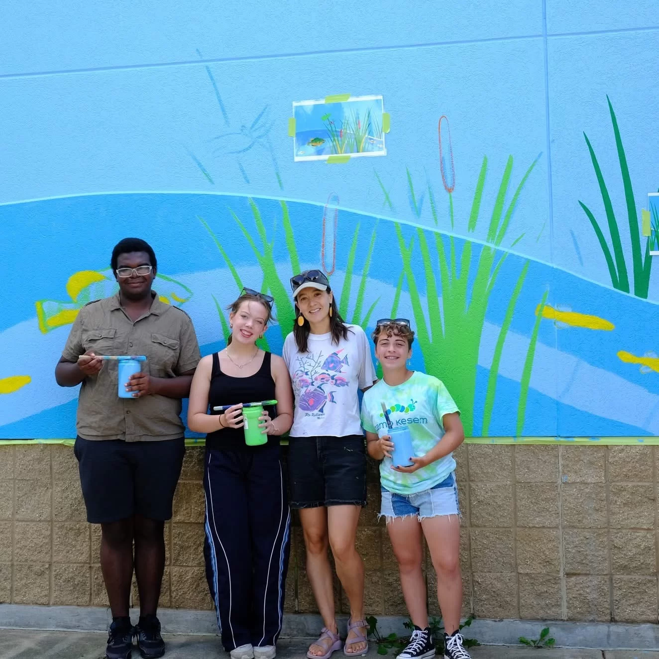 Artist Natalie Hinahara with Middleton High School students who helped her create the mural at Bauman Community Pool in Middleton Wisconsin 