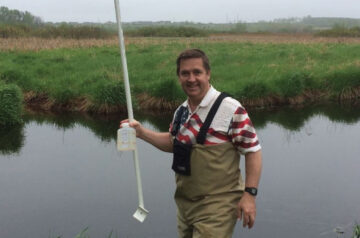 Friends of Pheasant Branch Conservancy Board Member Rick Eilertson doing monitoring work on Pheasant Branch Creek