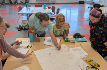 Friends of Pheasant Branch Conservancy volunteers working in a classroom