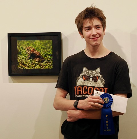 Middleton high school student Kai Thompson poses with his winning photo